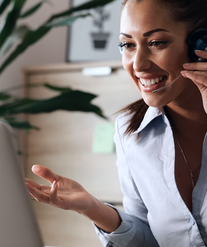 A support team member smiling during a phone call